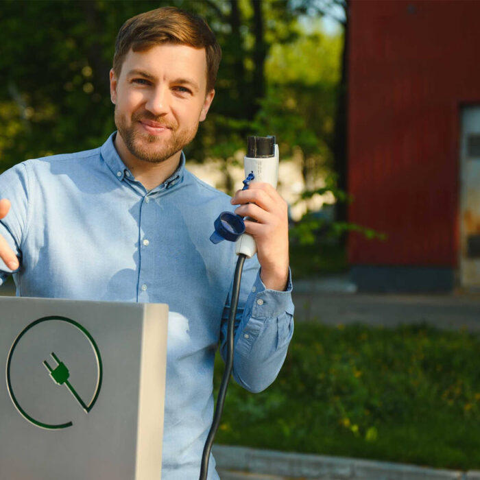 portrait-of-a-young-man-standing-with-charging-cab-G74WGRP.jpg